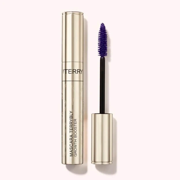 5 Beauty Trends to Embrace for Fall & Winter 2025 - 7 A gold tube of By Terry Mascara Terrybly Growth Booster with the wand removed, showing a purple mascara brush.