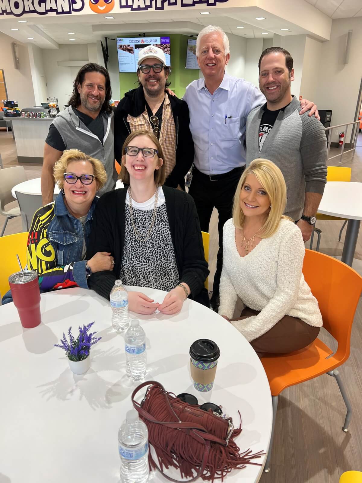 From the Newsroom to Morgan’s Wonderland: Leslie Mouton’s Story of Purpose - 4 Leslie Mouton with the Harman family sitting in chair around a table