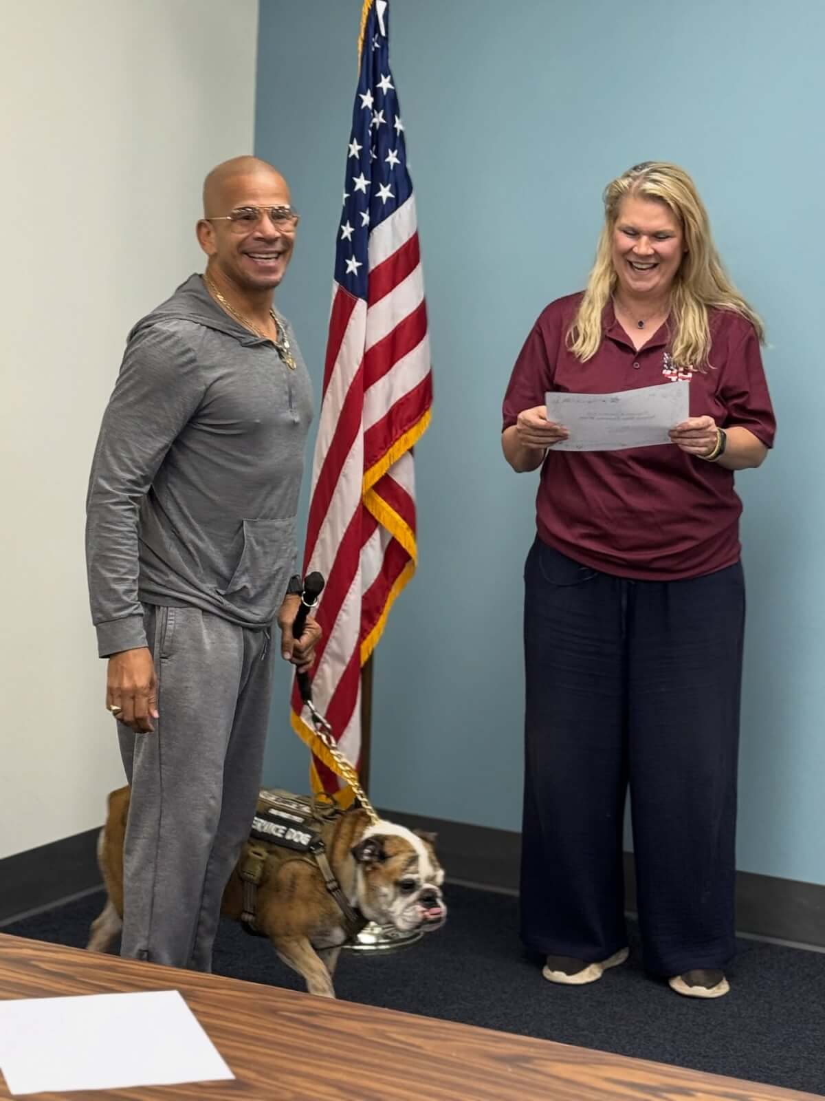 6 Organizations Pairing Canines and Veterans Across the South - 5 A man holding a canine on a leash stands next to Piper Hill, founder of Healing 4 Heroes, during a graduation ceremony from the organization's service dog training program.