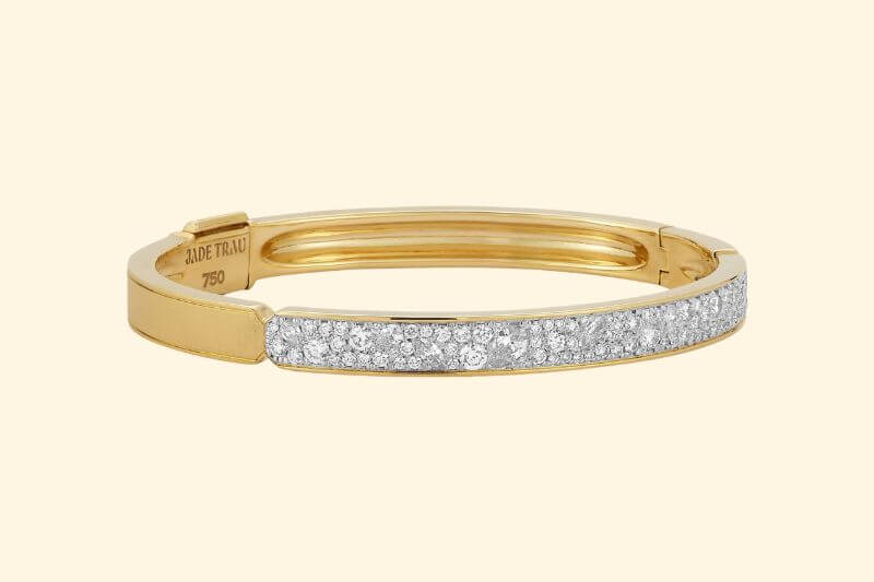 19 Luxurious Birmingham FINDS for the Holidays - 3 A gold bangle bracelet featuring a row of pave-set diamonds on the front section, with an engraved interior marked "750"—a luxurious Birmingham holiday find perfect for special occasions.