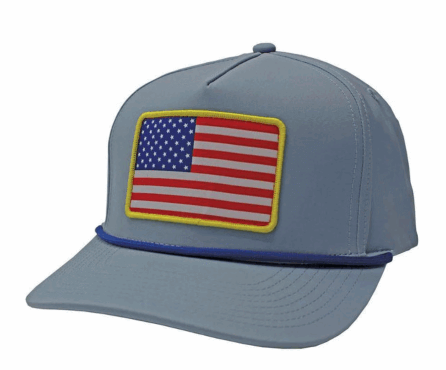 50 Under $50: Your BHAM Holiday Gift Guide - 39 A light blue baseball cap featuring a rectangular patch of the American flag with a yellow border on the front and a dark blue accent band above the visor—perfect for holiday gifts or as a stylish find from the Birmingham holiday gift guide.
