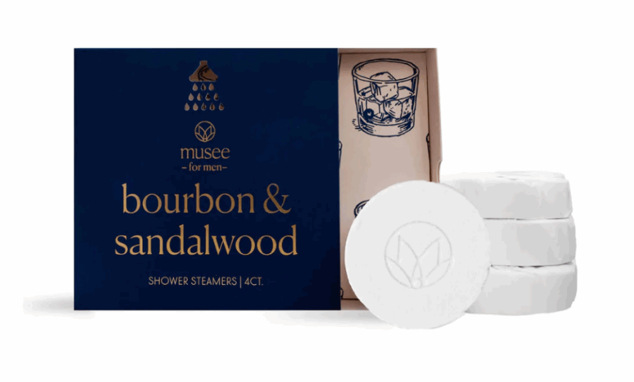 50 Under $50: Your BHAM Holiday Gift Guide - 44 A box labeled "bourbon & sandalwood shower steamers" is open to show four round white steamers, with an illustration of a drink inside the lid—a refreshing pick from the Birmingham Holiday Gift Guide for holiday gifts under $50.