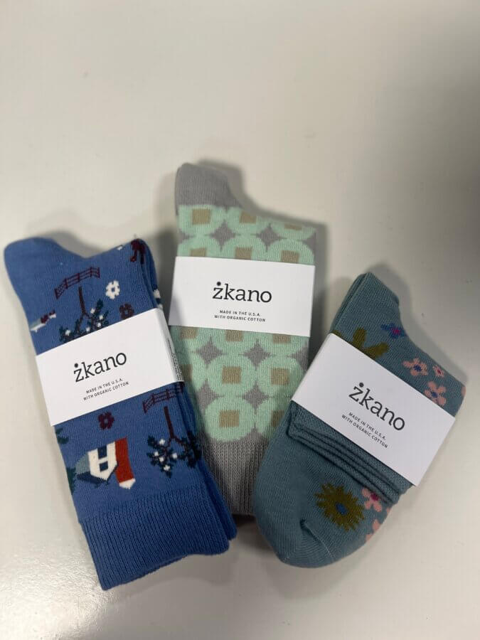 50 Under $50: Your BHAM Holiday Gift Guide - 10 Three pairs of patterned Zkano brand cotton socks, each with a different colorful design, displayed on a white surface.