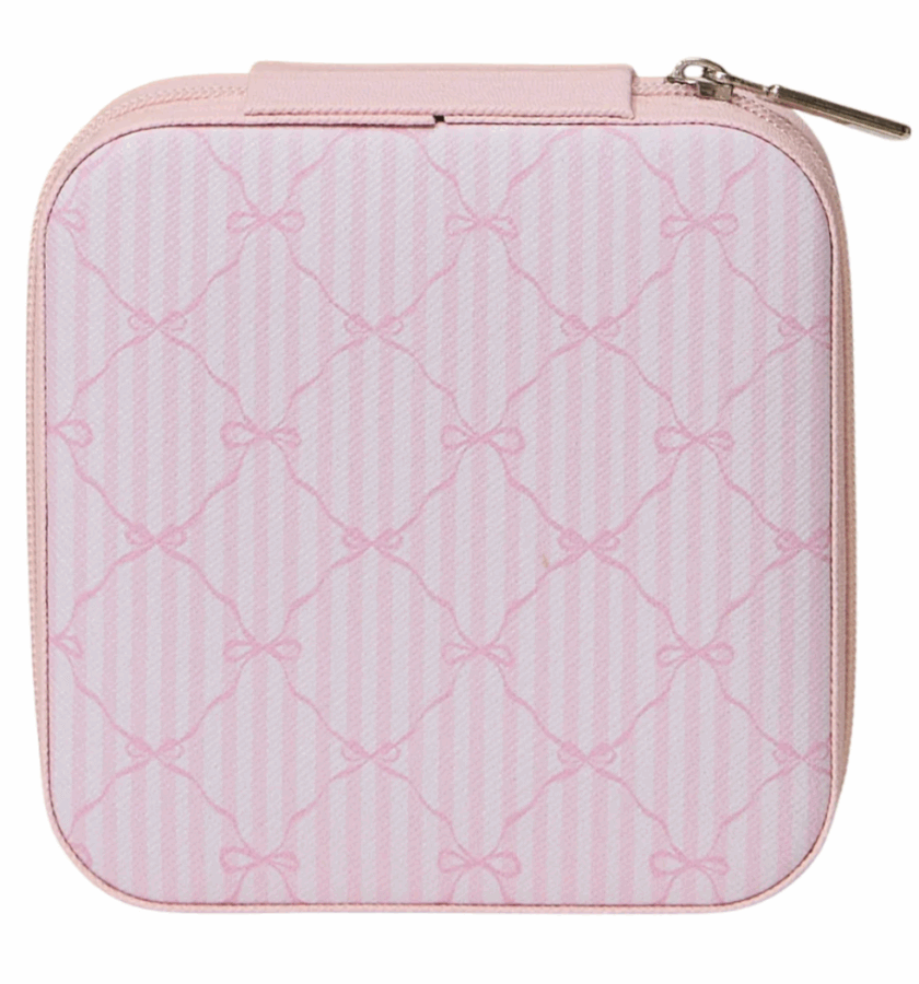 50 Under $50: Your BHAM Holiday Gift Guide - 47 A square light pink zippered pouch with a subtle striped and bow pattern on the exterior—perfect for your 2025 Holiday Gift Guide or as a charming Birmingham-inspired accessory.