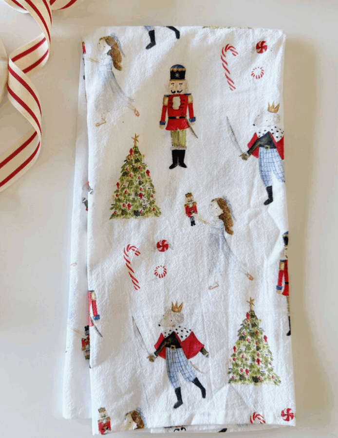 50 Under $50: Your BHAM Holiday Gift Guide - 27 White cloth with illustrations of nutcracker soldiers, ballerinas, Christmas trees, candy canes, and regal mice—perfect for your 2025 Holiday Gift Guide or as a festive touch to your Birmingham celebrations.