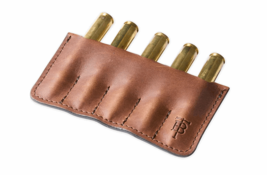50 Under $50: Your BHAM Holiday Gift Guide - 41 A brown leather ammunition holder with five rifle cartridges inserted, featuring visible stitching and an embossed logo—an ideal pick for gifts under $50 and a stylish addition to any 2025 gifts list.