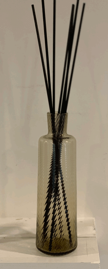 19 Luxurious Birmingham FINDS for the Holidays - 20 A clear glass bottle with a zigzag pattern holds several black diffuser reeds, capturing the essence of luxurious Birmingham and making it a perfect addition to your collection of luxury finds.