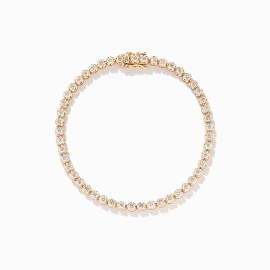 23 Luxurious Nashville FINDS for Holiday 2025 - 6 A luxe gold tennis bracelet set with round white gemstones arranged in a single line, displayed on a plain white background—perfect for adding holiday sparkle to your Nashville soirées.