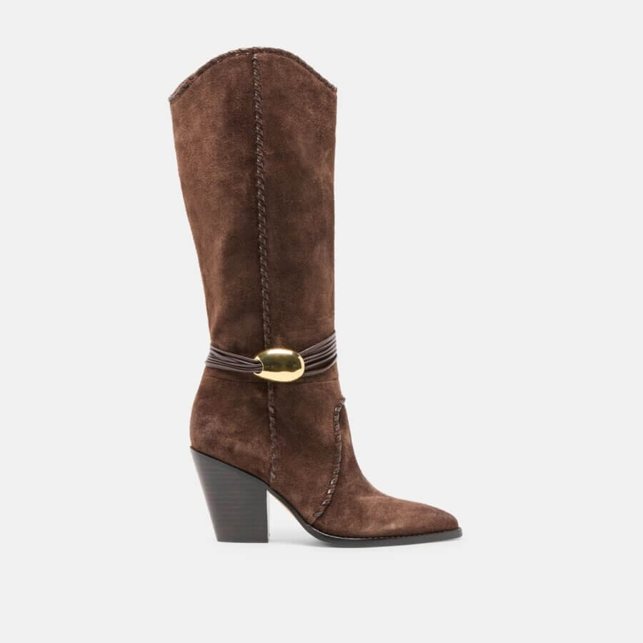 Brown suede knee-high boot with a pointed toe, chunky high heel, decorative stitching, and a gold buckle detail on the side—perfect for adding luxe style to your next holiday party or Nashville getaway.