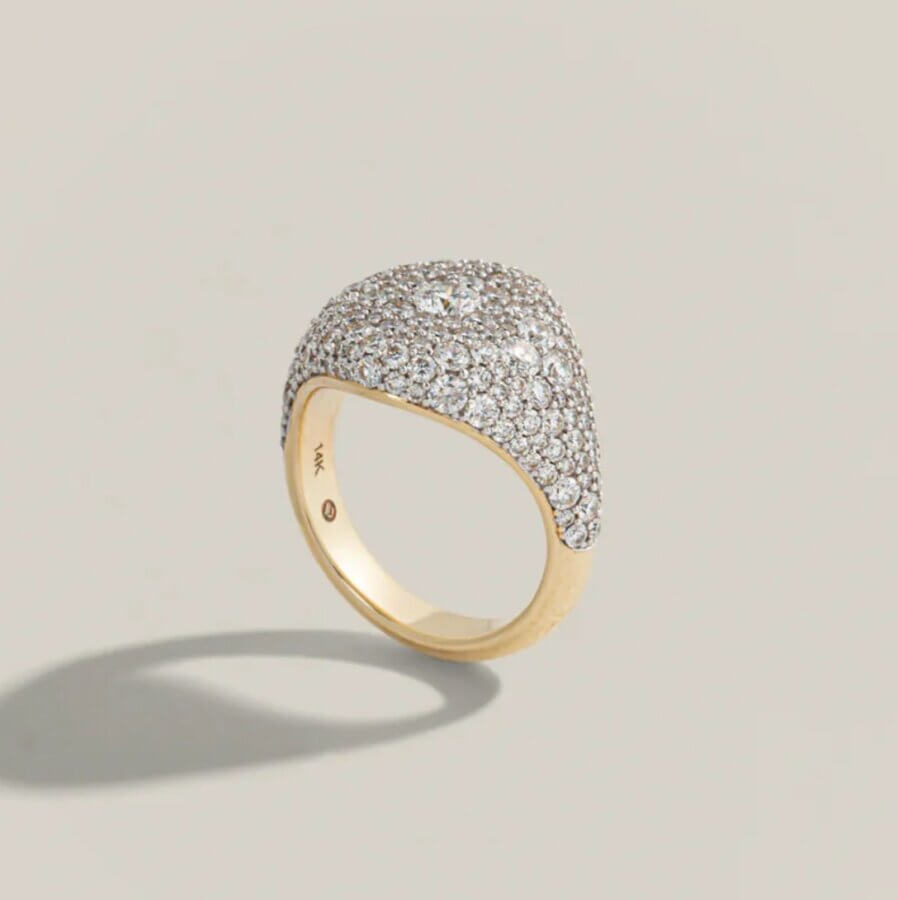 23 Luxurious Nashville FINDS for Holiday 2025 - 7 A luxe gold ring with a wide, domed top encrusted with numerous small diamonds, displayed against a neutral background—perfect for adding sparkle to any holiday celebration.