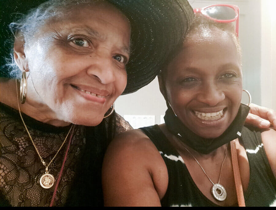 Meet Memphis Jazz Musician Cequita Monique - 3 Two women smiling for a selfie; Cequita Monique wears a black hat and lace top, while her friend has sunglasses on her head and a black mask around her neck.