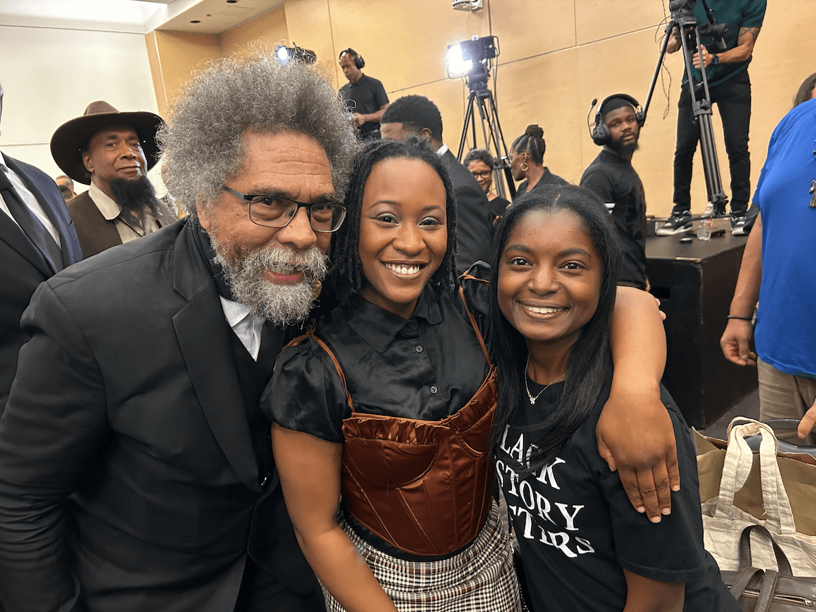 Meet the Woman Behind the New Memphis Rap Tour - 5 Three people stand close together, smiling at the camera at an indoor FACES event. The man on the left has gray hair and glasses; Taylor Nicole Barksdale and another woman beside him have their arms around each other.