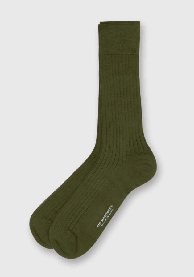 50 Under $50: Your Nashville Holiday Gift Guide - 42 A pair of ribbed, olive green crew socks is laid flat on a light background. Perfect for Nashville fans or as thoughtful gifts under $50, the socks feature minimal text near the toe area.