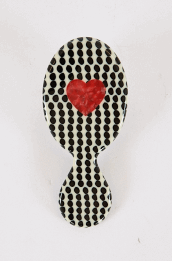 50 Under $50: Your Nashville Holiday Gift Guide - 20 A handheld oval mirror with a black polka dot pattern and a red heart design in the center, perfect for any Nashville lover or Holiday Gift Guide, set against a plain white background.