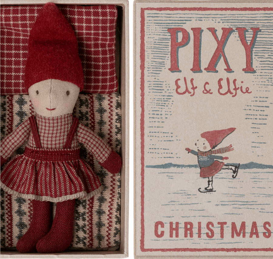 50 Under $50: Your Nashville Holiday Gift Guide - 48 A cloth doll in red and gray winter clothes is in a box next to packaging labeled βPixy Elf & Elfie Christmasβ with a skating elfβan adorable Nashville find perfect for any Holiday Gift Guide and gifts under $50.