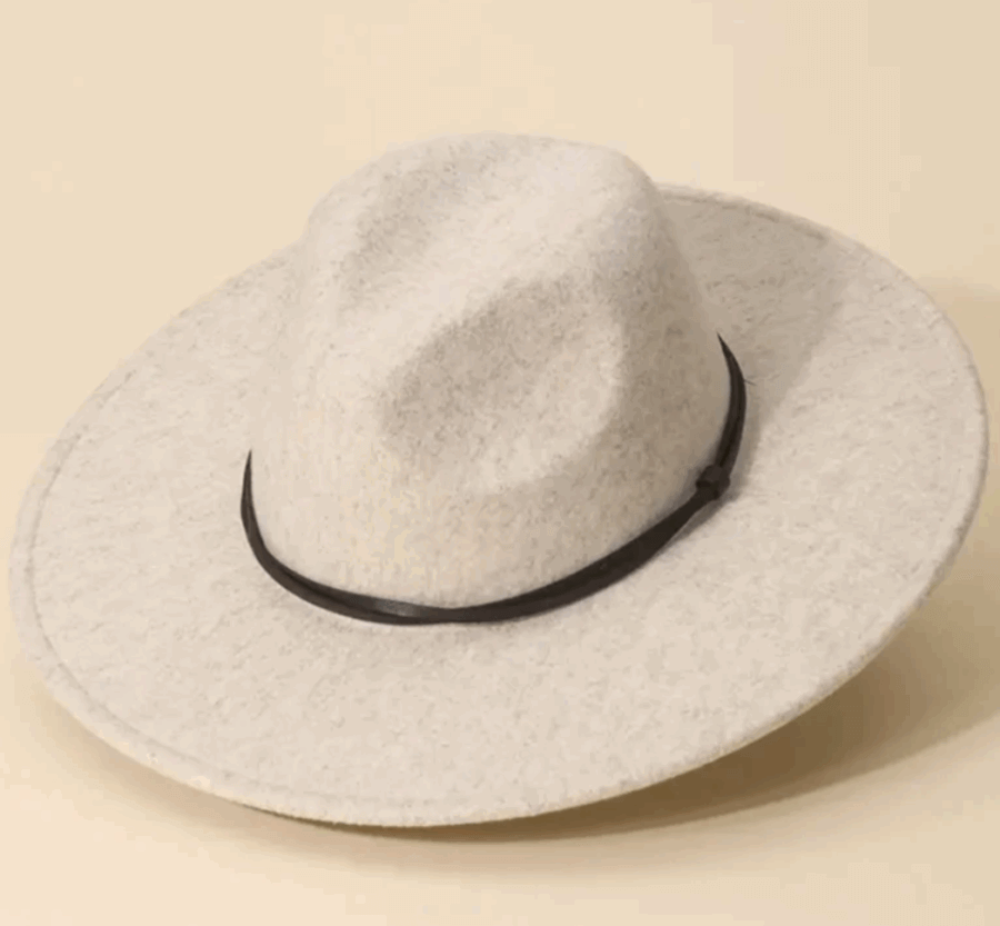 50 Under $50: Your Nashville Holiday Gift Guide - 27 A light gray wide-brimmed felt hat with a black band, inspired by Nashville style, sits on a neutral background.