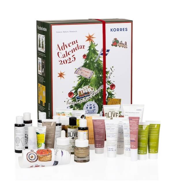 The BEST Advent Calendars for 2025 - 4 The Korres Advent Calendar 2025 box is displayed behind an assortment of skincare and beauty product tubes, bottles, and jars—capturing the excitement advent calendars bring to every beauty routine.