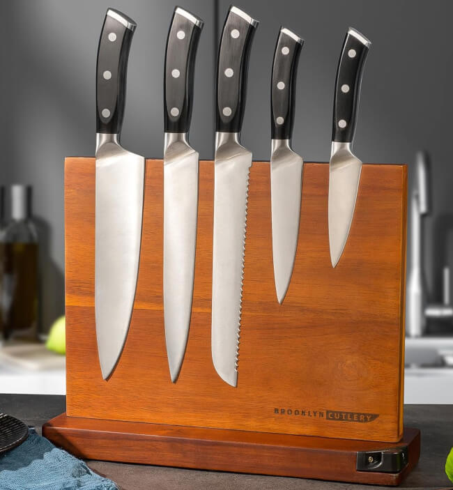 12 Nashville Chefs Share Their Go-To Culinary Gifts to Give - 12 Five kitchen knives with black handles are displayed in a wooden knife block labeled "Brooklyn Cutlery" on a Nashville kitchen counter—an ideal pick for culinary insiders or thoughtful holiday gifts.