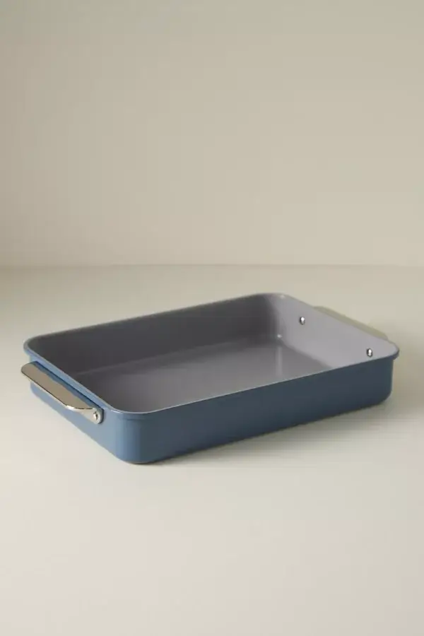 10 Gifts For Bakers Under $100 - 9 A rectangular blue baking pan with metal handles sits on a light surface against a plain backgroundβan ideal pick for baking gifts or thoughtful gifts for bakers.
