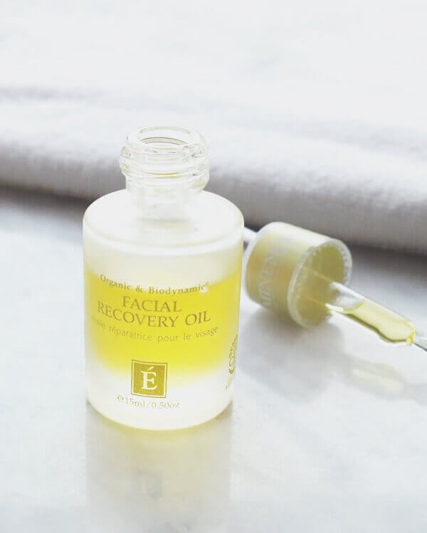 Birmingham's 10 Most Popular Articles of 2025 - 6 A small bottle labeled "Facial Recovery Oil" with an open dropper filled with yellow oil rests on a light surface, featured in popular articles from Birmingham for 2025 skincare trends.