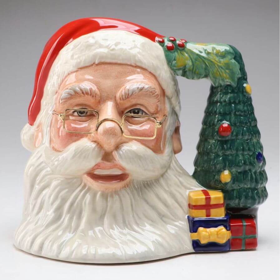 Stop Donating These 5 Items — They May Be Worth Serious Cash - 7 A ceramic Santa Claus mug with a Christmas tree handle and small gift boxes at the base, set against a plain background—perfect for gifting or donating items to spread holiday cheer.
