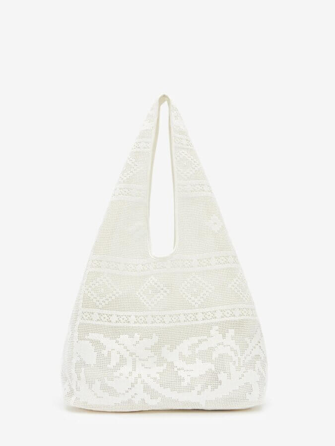 Trend Alert: Lace is Back! - 18 Trend alert: White crochet hobo bag with a triangular shape, wide base, single shoulder strap, and lace-inspired floral pattern, set against a plain white background.