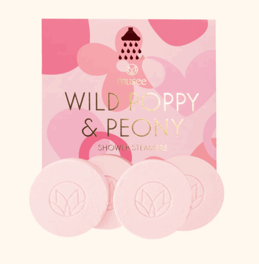 17 Birmingham FINDS for the New Year - 12 A package of Musee Wild Poppy & Peony shower steamers, a Birmingham FINDS favorite, is shown with three round pink steamers displayed in front of a pink box.