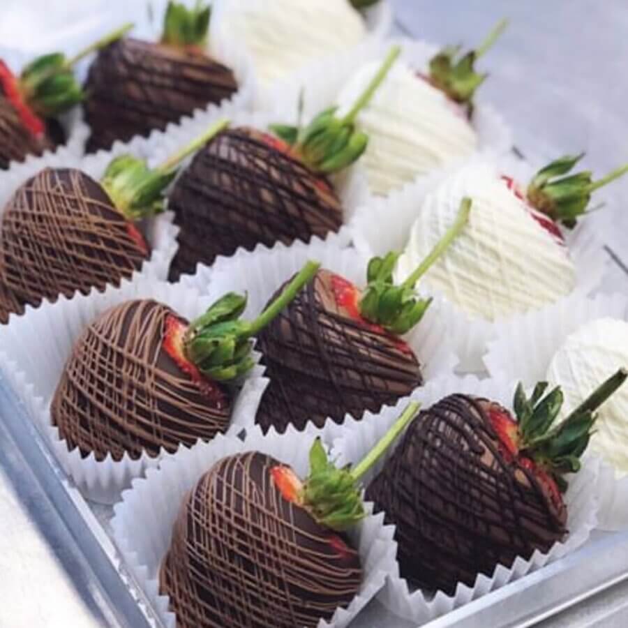 4 Decadent BHAM Chocolate Shops You Need to Know About - 5 A tray of strawberries coated in dark and white chocolate, each drizzled with chocolate and placed in individual paper cups—a perfect treat from Magic City chocolate shops for Valentine’s Day.