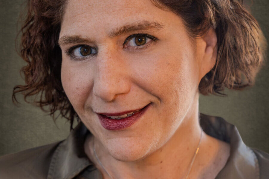 Honoring the 1.5 Million: Leah Fox-Greenberg and the Mission of the Unknown Child Foundation - 2 An unknown child with short curly brown hair and brown eyes, wearing a gray collared shirt, looks at the camera and smiles slightly.