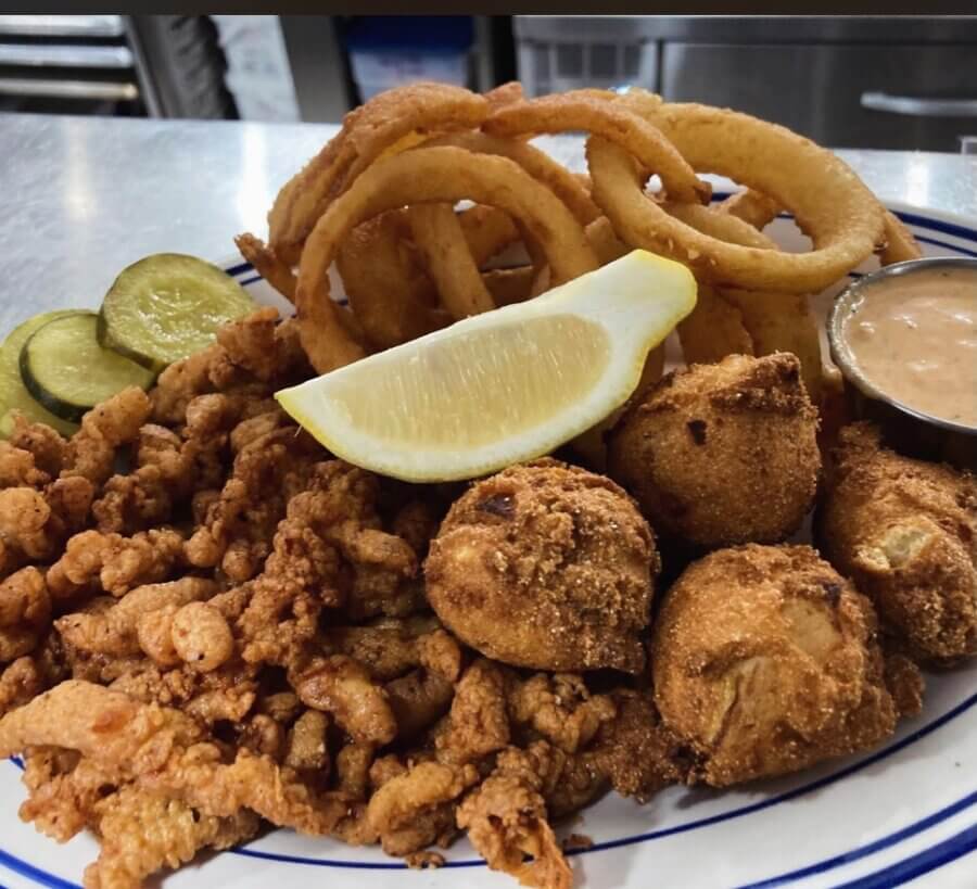 4 New Louisville Restaurants (+2 New Menus!) to Try This Month - 13 A plate with fried clam strips, hush puppies, onion rings, pickle slices, a lemon wedge, and a side of dipping sauce.