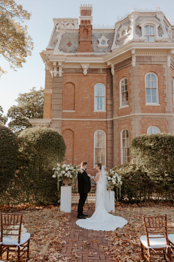 An Elegant Memphis Wedding at The Historic James Lee House - 3 A bride and groom stand at the alter in front of The James Lee House.