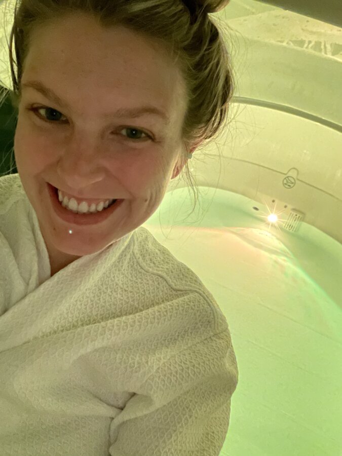 Meet Jasmin Day of Ease Wellness & JDay Bakes - 4 Jasmin smiles for a selfie in front of a float tub.