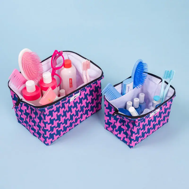 15 Memphis FINDS to See You Through January - 11 Two patterned fabric storage bins hold various personal care items, including brushes, bottles, and toothbrushesβperfect for organizing your Memphis Finds against a light blue background.