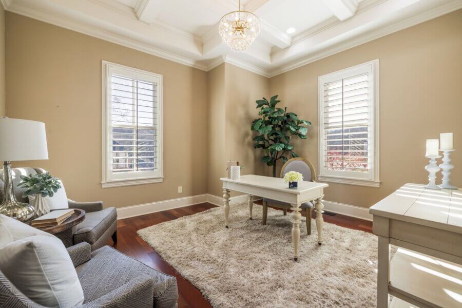 Just Listed! A Franklin Home Designed to Entertain & Unwind - 5 Just Listed! This bright Franklin Home office features a white desk, upholstered chairs, shaggy rug, potted plant, and large windows with white shutters—a perfect space to work or entertain guests.