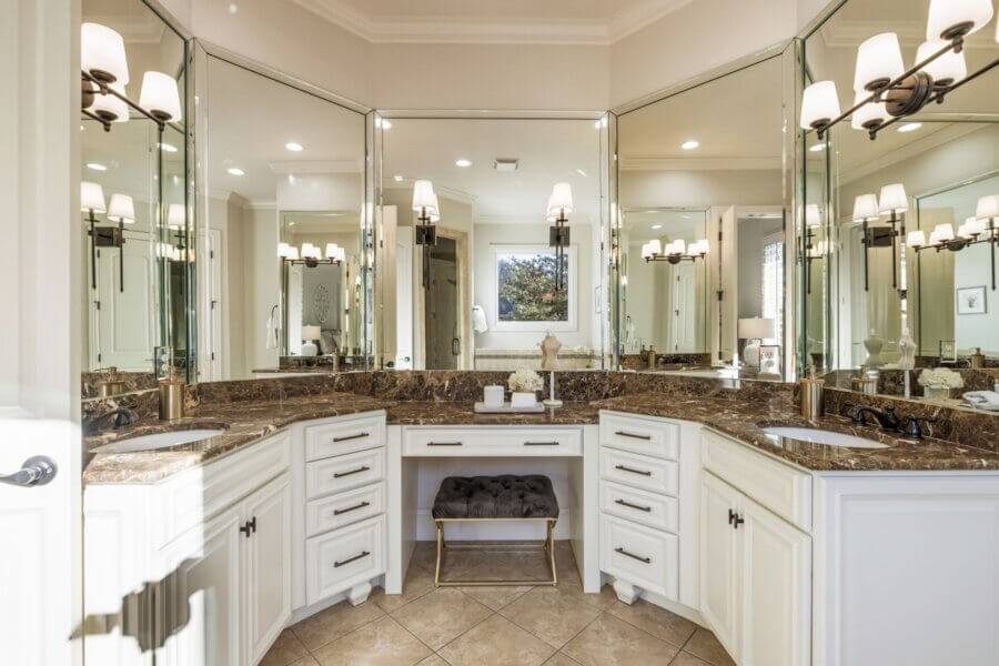 Just Listed! A Franklin Home Designed to Entertain & Unwind - 14 Just Listed! This Franklin Home features a spacious bathroom with a marble countertop, white cabinets, a central vanity area with a bench, and mirrored walls reflecting multiple light fixtures—perfect to entertain and impress your guests.