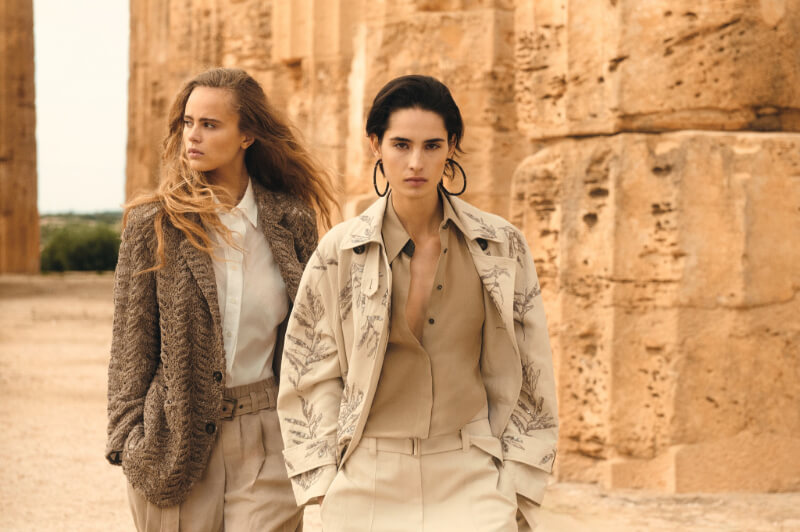 Coming Soon to Nashville! 10 Exciting Additions - 7 Two women in neutral-toned, stylish outfits walk beside ancient stone columns outdoors in Nashville, blending modern fashion with timeless architecture—an inspiring glimpse of 2026 style.
