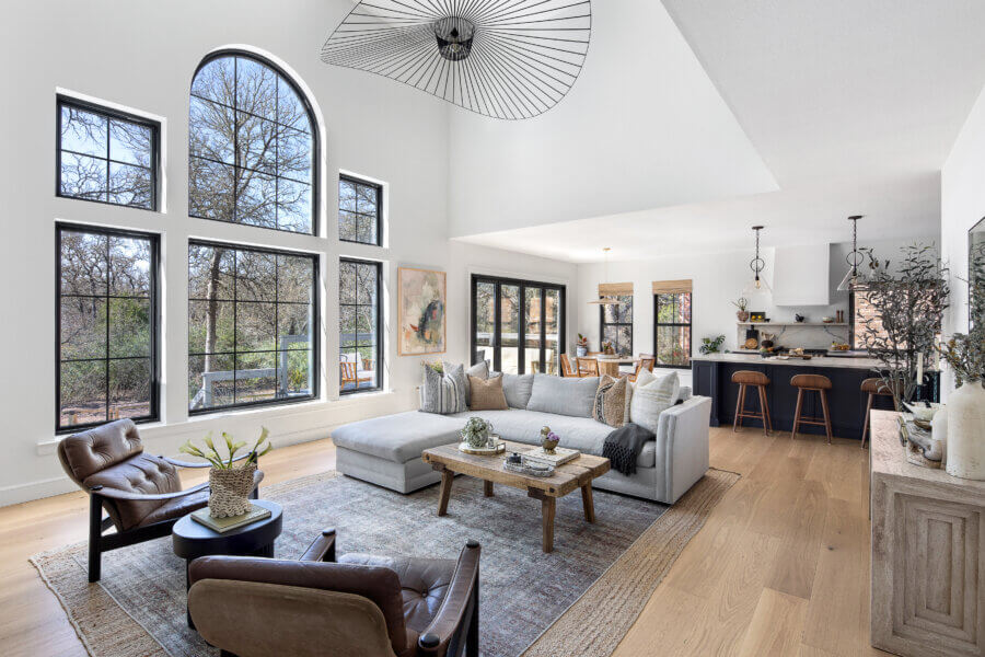 Step Inside an Austin Interior Designer’s Home - 2 Modern living room designed by an Austin interior designer, featuring vaulted ceilings and large windows.