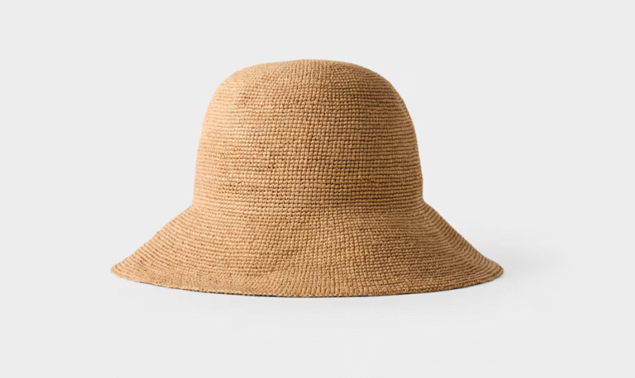 8 Crushable Hats, Perfect for Travel - 4 A natural-colored, wide-brimmed woven straw hat displayed on a plain, light gray background—ideal among packable hats for effortless style on your next getaway.