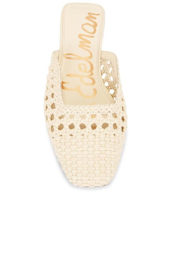 6 Spring 2026 Fashion Trends + How to Wear Them - 14 A woven cream-colored mule sandal with a square toe and gold “Edelman” branding on the insole.