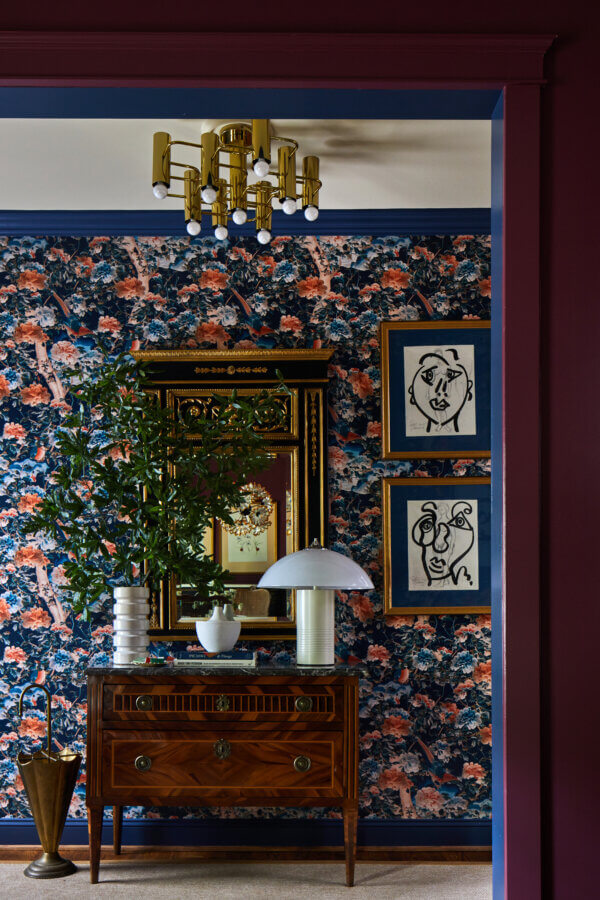 Something Old, Something New: How Ellie Christopher Makes Antiques Feel Fresh - 4 Dark blue floral wallpaper behind antique chest and mirror