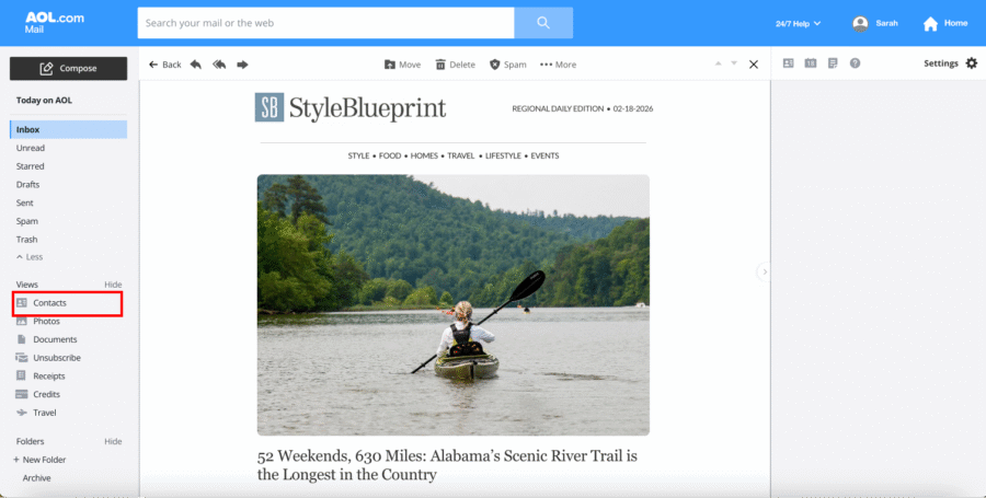AOL Inbox Guide - 1 A person kayaks on a calm river surrounded by green, forested hills, as featured in a StyleBlueprint guide displayed in an AOL Mail inbox.