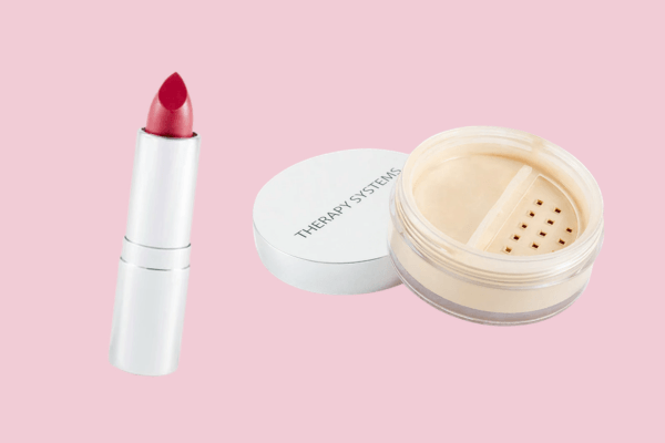 Nashville's Spring 2026 Style Edit: Playful Layers, '90s Inspiration & More - 8 A red lipstick in a silver tube and a container of loose face powder labeled "Therapy Systems" are displayed on a pink background, perfect for adding a touch of Nashville-inspired flair to your spring fashion routine.