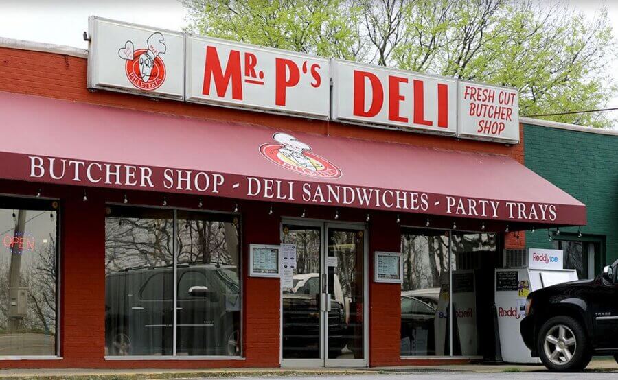 Your Guide to BHAM's Bluff Park - 7 Exterior view of Mr. P's Deli in Bluff Park, featuring a red awning and signage advertising a butcher shop, deli sandwiches, and party trays—a must-stop for any Bluff Park travel or guide adventure.