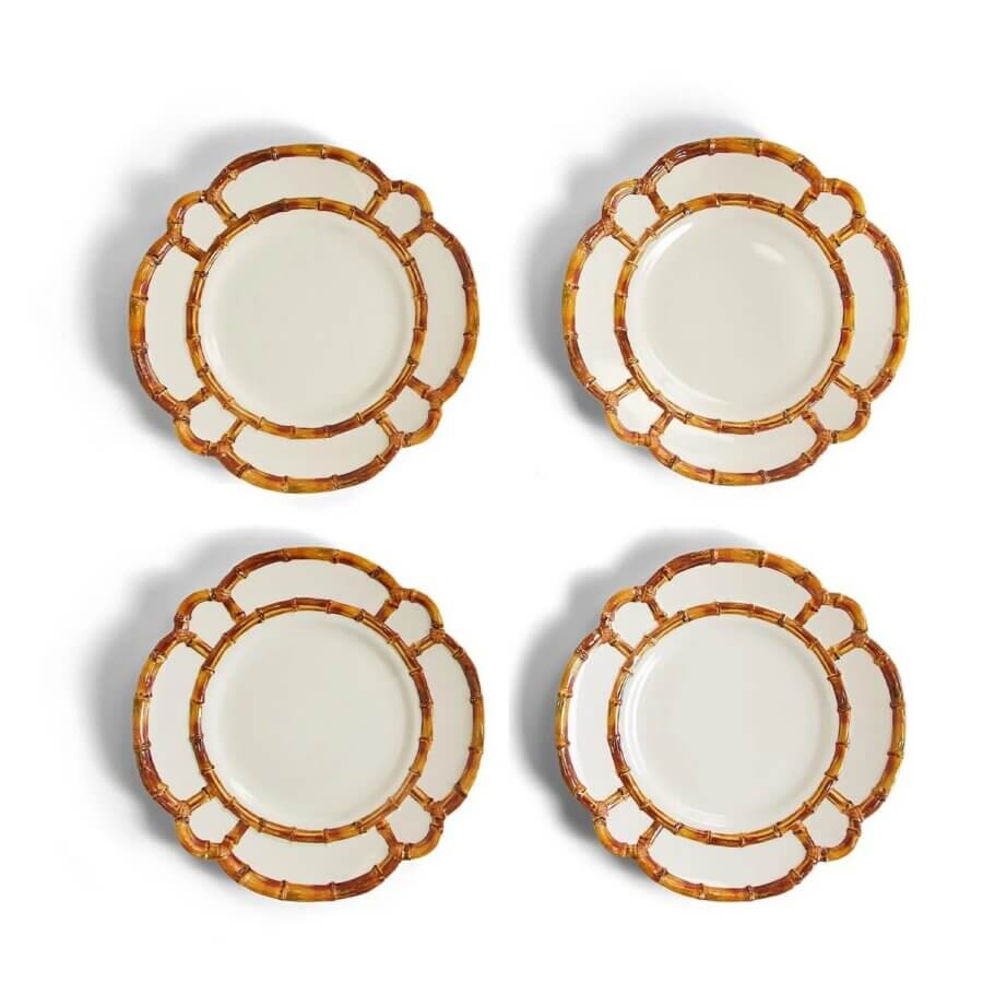18 Nashville FINDS We're Loving This Month - 14 Four round white plates with a decorative brown and gold bamboo-patterned rim, arranged in a grid on a white background. This elegant set is part of the FINDS Draft from March 2026.