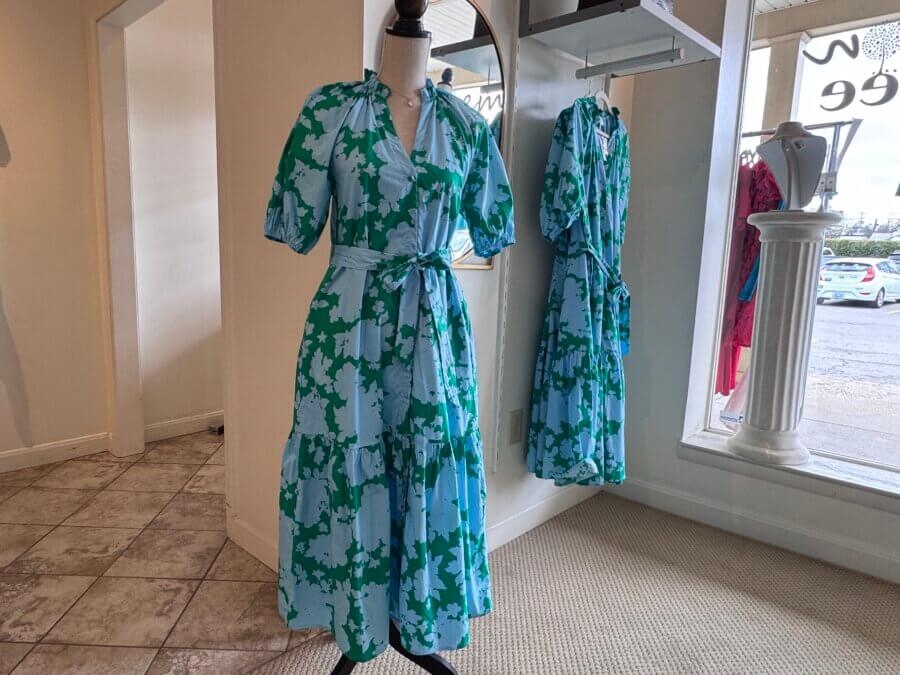 16 Louisville FINDS for April: Spring Style, Derby-Ready Decor & Must-Have Gifts - 2 A mannequin displays a blue and white floral wrap dress with a tie belt in a Louisville boutique; the perfect spring find is also reflected in a nearby mirror.