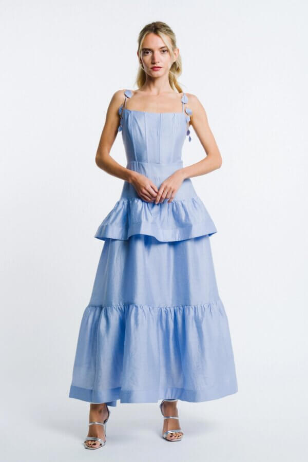 15 Memphis FINDS at Local Shops: Spring Dresses, Home Decor & More! - 3 Woman wearing a sleeveless, light blue tiered maxi dress with tie straps, featured in the Memphis FINDS March collection, standing against a plain white background.