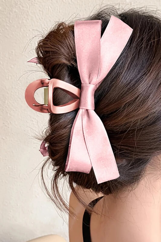 15 Memphis FINDS at Local Shops: Spring Dresses, Home Decor & More! - 10 A womanβs hair is styled in an updo and secured with a large pink hair clip featuring a matching bowβa charming look perfect for your next Memphis FINDS this March.