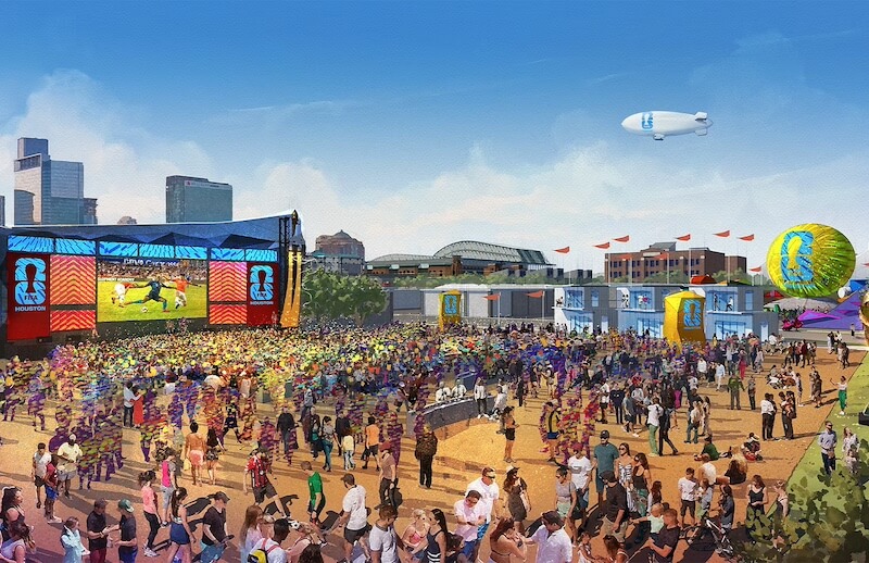 The Southerner's Guide to the 2026 World Cup - 7 Large crowd gathers outdoors at a World Cup fan festival with big screens, colorful decorations, food stalls, and a blimp flying overhead; city buildings visible in the background.