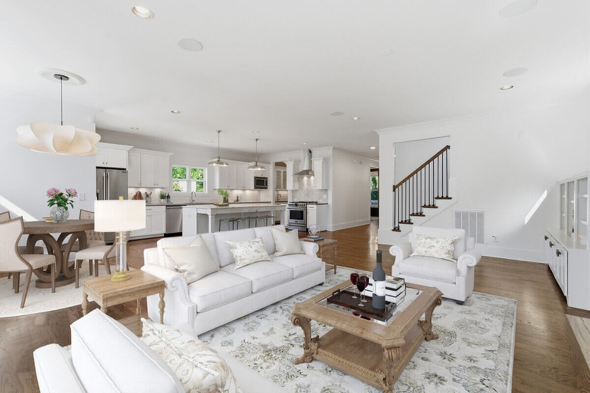 Open-concept living room and kitchen with white walls, white furniture, wooden floors, and natural light; a dining area is visible on the left in this stylish Nashville TN home at 98 44th Ave N.