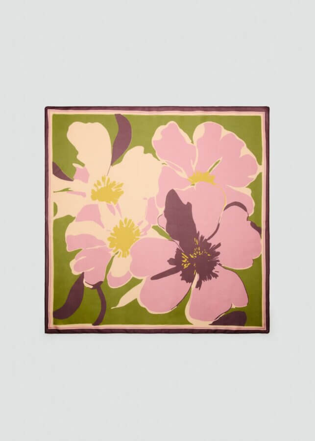 It's the Year of the Brooch! Here's How to Style Them - 5 Square scarf featuring a large abstract floral print in shades of pink, cream, and purple on a green background with a dark borderβperfect for pairing with your favorite brooch for an elegant finishing touch.